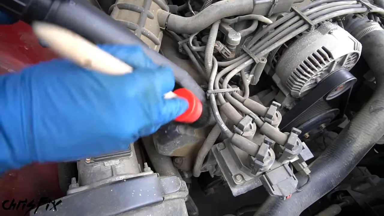 Detailing brush and vacuum nozzle cleaning around intake tubing and ignition wires