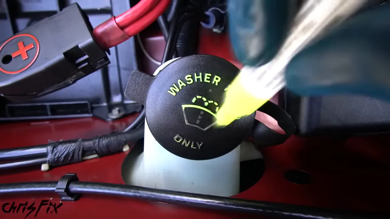 Washer fluid cap with bright yellow lettering and windshield washer symbol