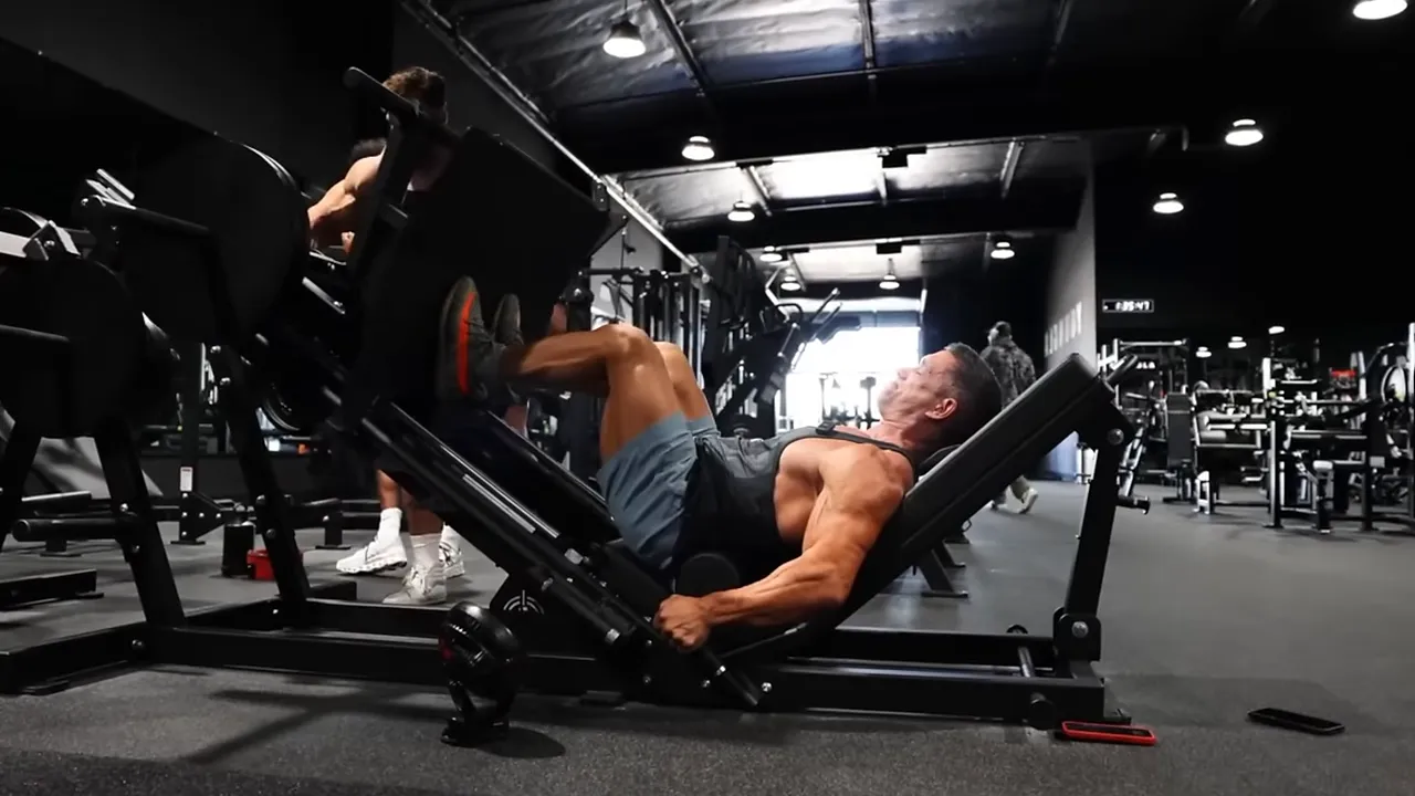 Greg Doucette performing a leg press with deeply bent knees