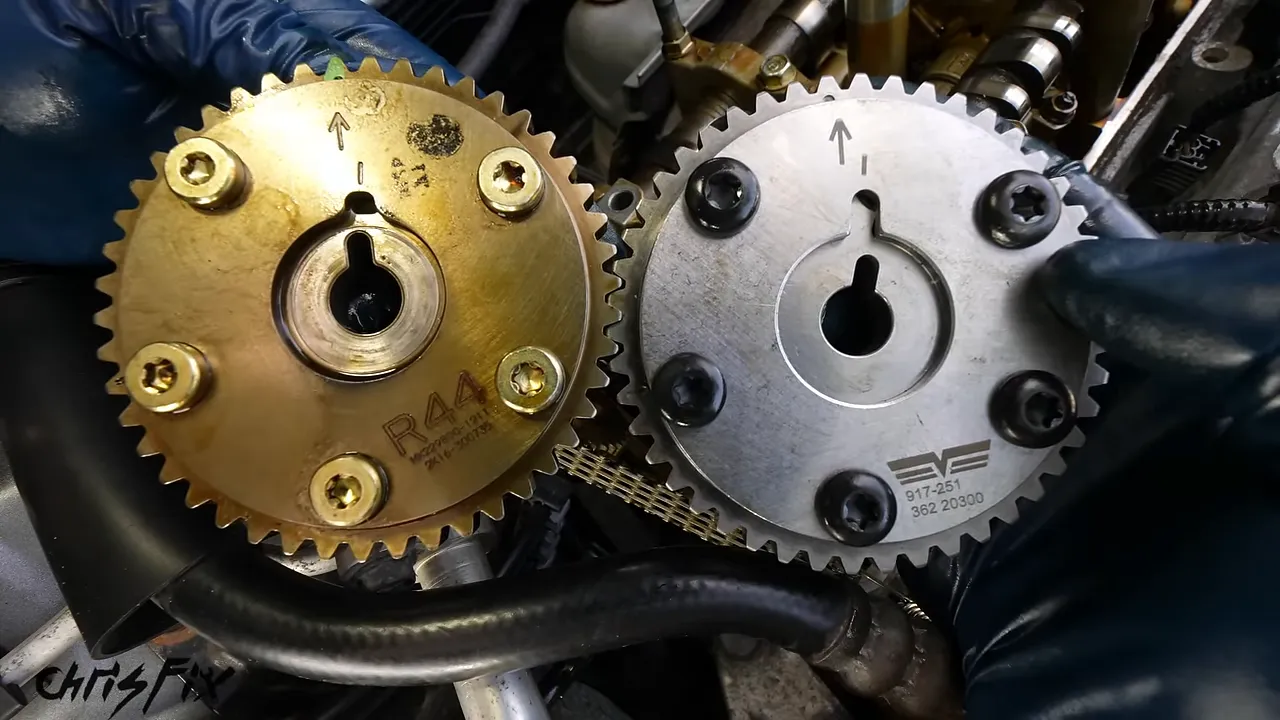 Old gold-colored VTC actuator beside a new silver actuator with different center keyway positions