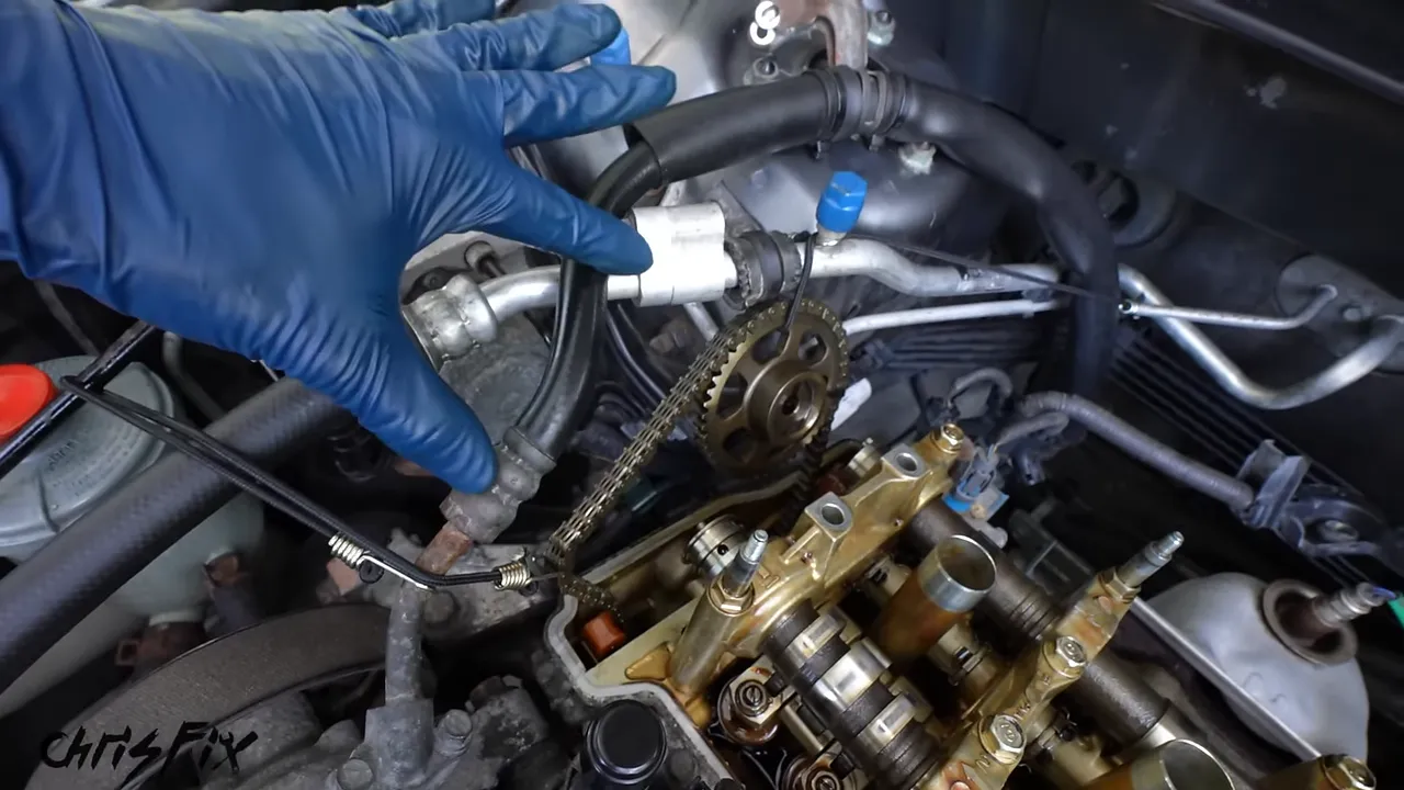 Timing chain and exhaust sprocket held above the open engine by support cords