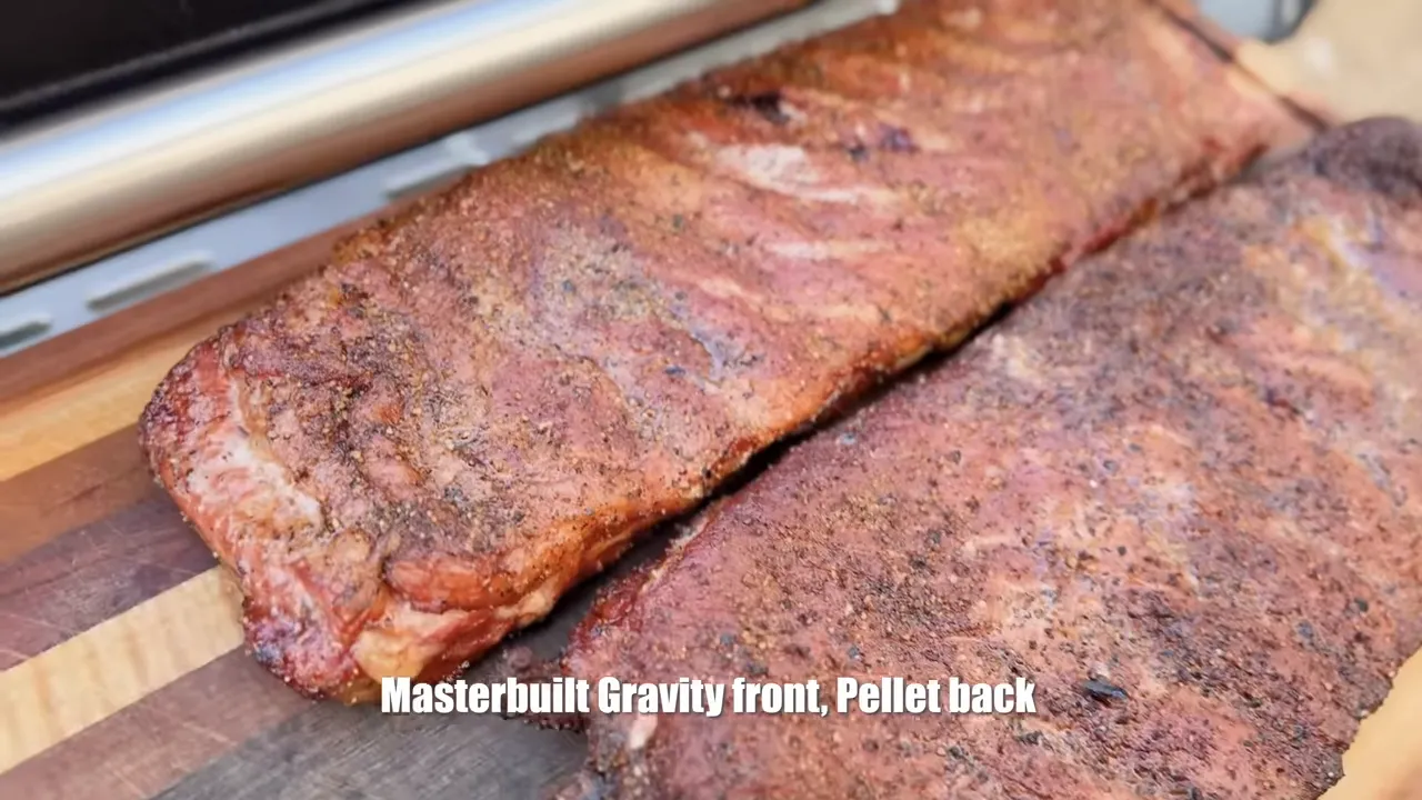 Two cooked rib racks on a cutting board with darker ribs in front and lighter ribs behind