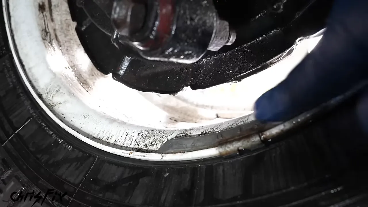 Gear oil collected inside the white rear wheel beneath the brake backing plate