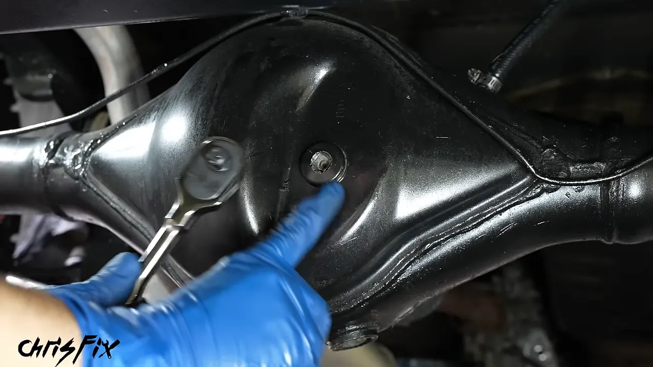 A 3/8-inch ratchet fitted into the differential fill plug