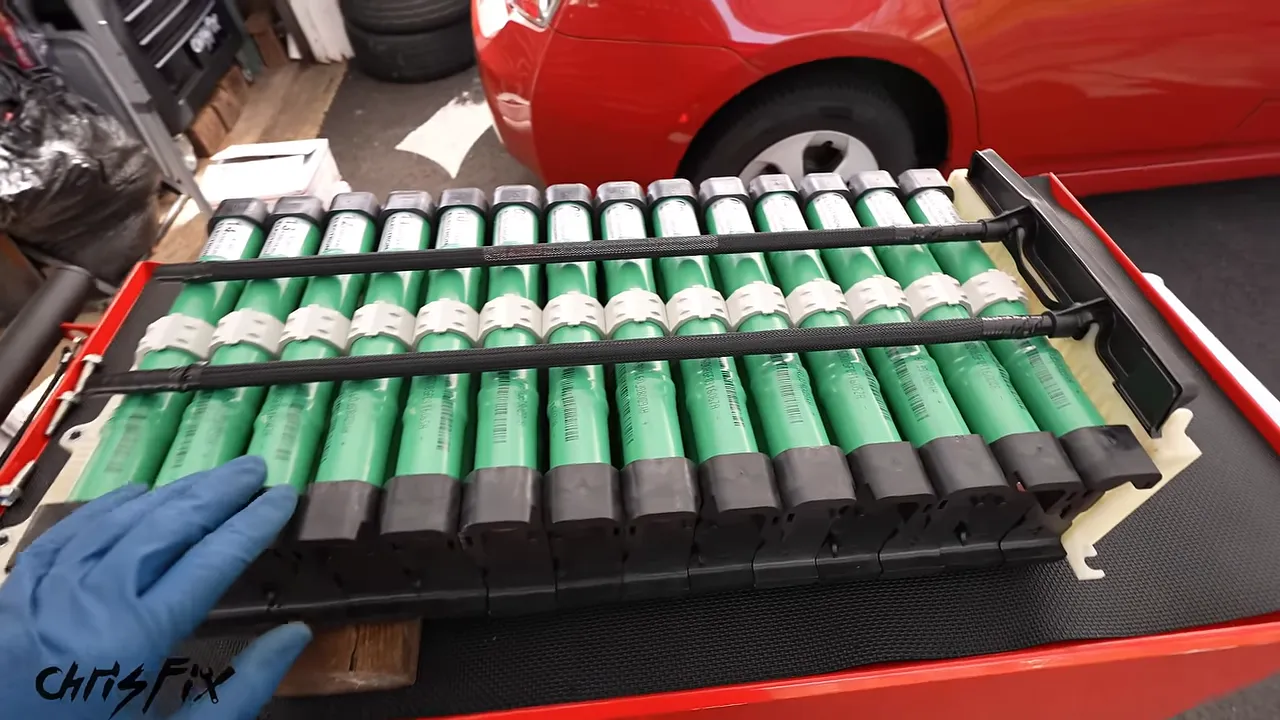 Numbered green cylindrical battery assemblies installed between the battery frame rails