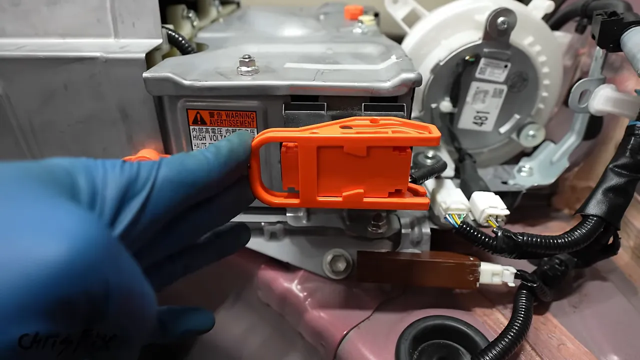 Orange hybrid battery service plug fully seated with its handle in the locked position