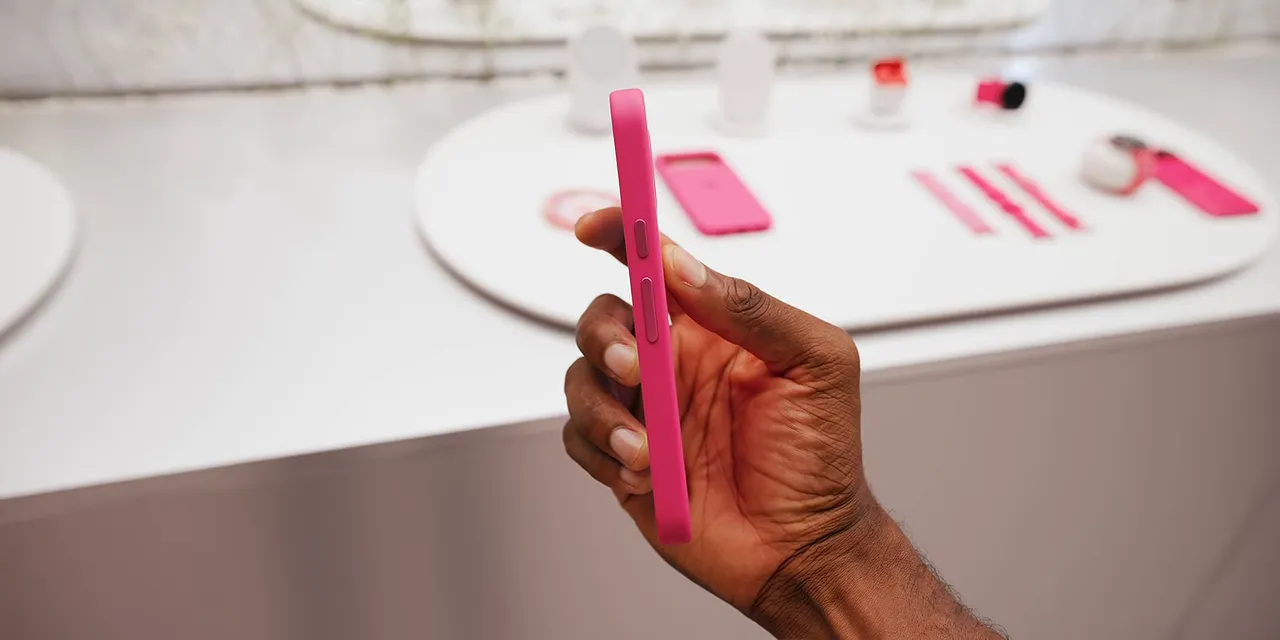 Fuchsia Pixel held sideways in a matching case with the camera bar nearly flush with the back