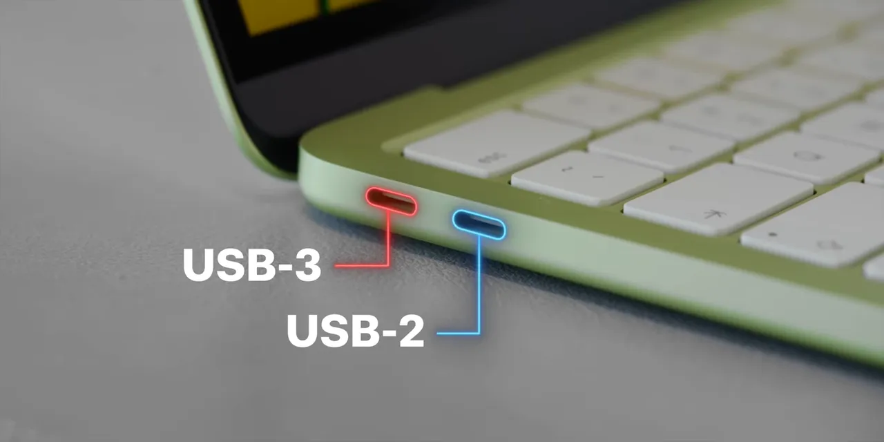 Close-up of two USB-C ports labeled USB-3 and USB-2 on the citrus MacBook Neo