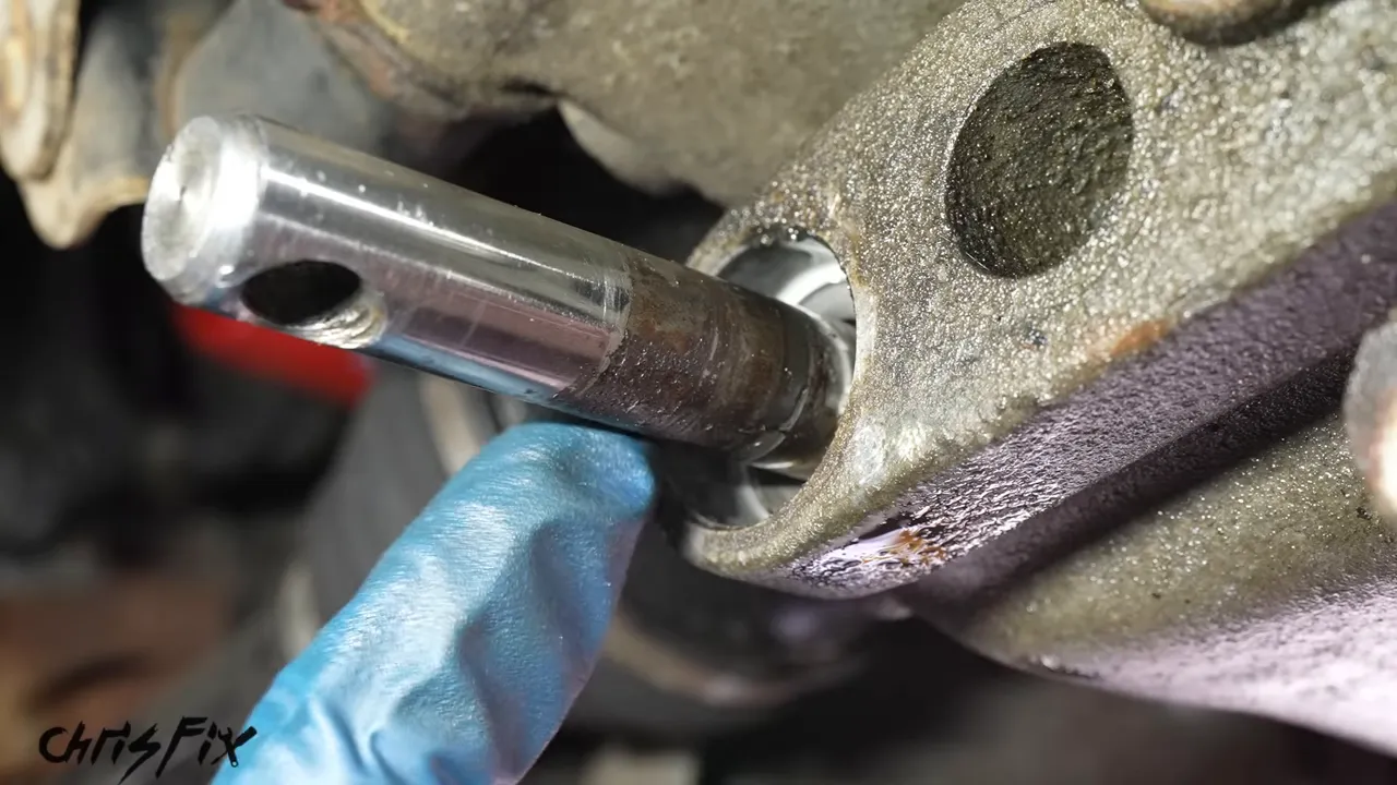 Close-up of corrosion on the transmission selector shaft beside the seal opening