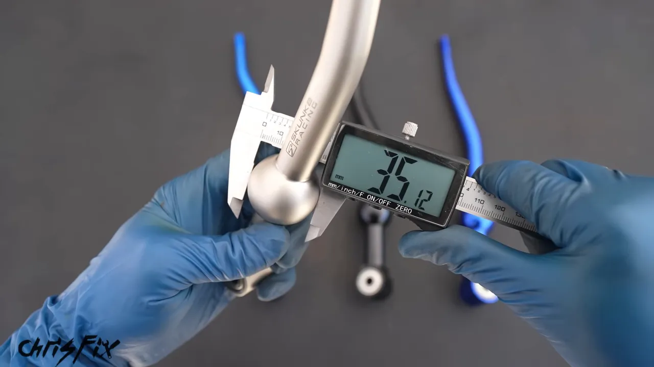 Digital calipers measuring the ball on a silver aftermarket shifter