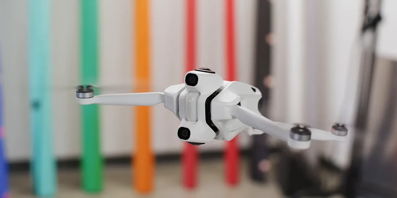 White Antigravity A1 hovering indoors with lenses above and below its body