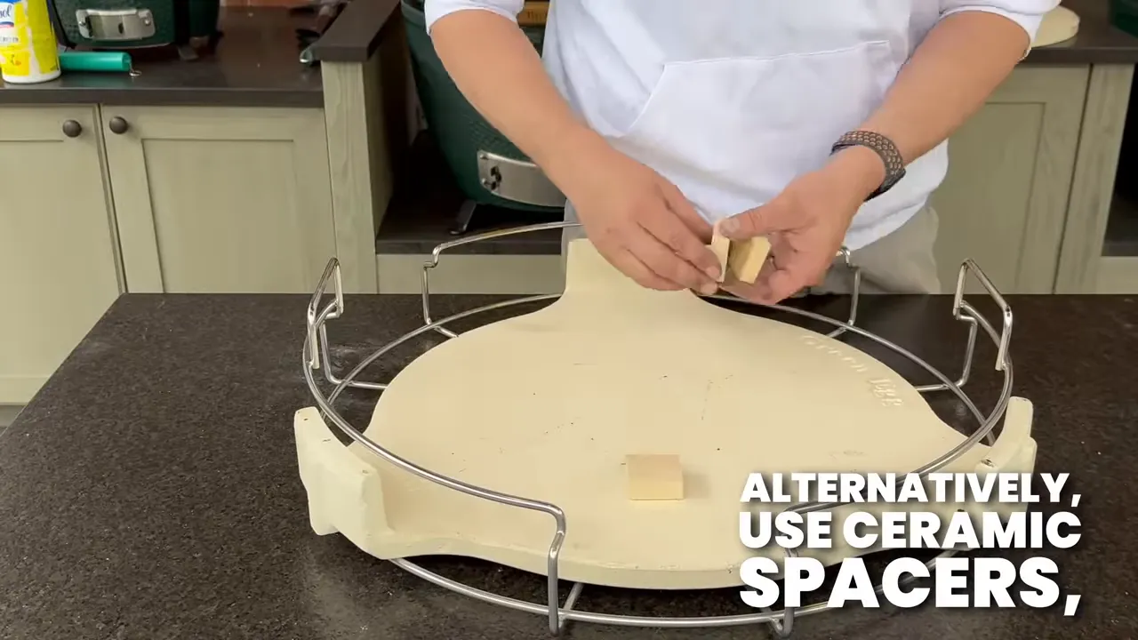 Ceramic spacers positioned on a convEGGtor beneath a pizza stone held above it