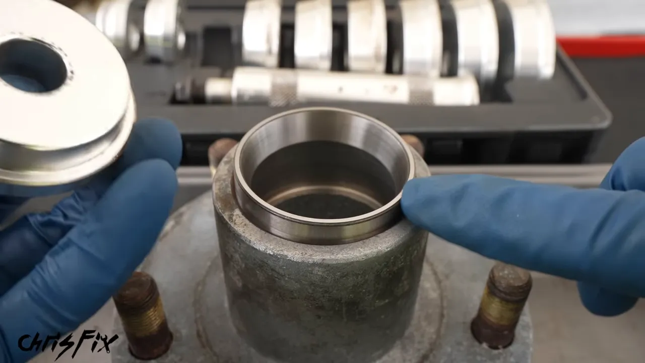 Round bearing race driver resting squarely over the race in a trailer hub