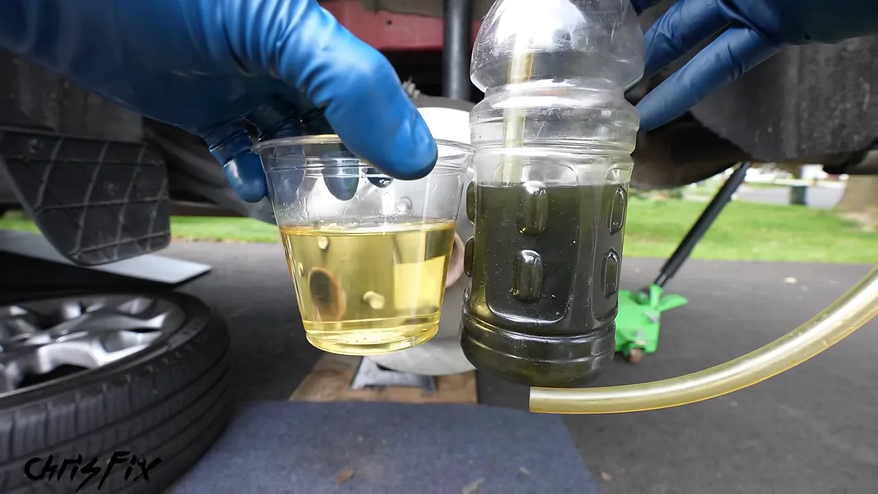 Container of fresh yellow brake fluid beside a bottle of dark used brake fluid