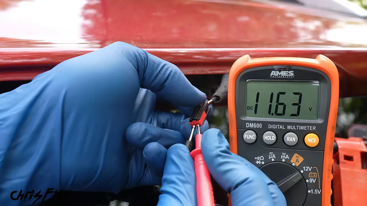Multimeter reading about 11.6 volts while probes contact the brake light connector