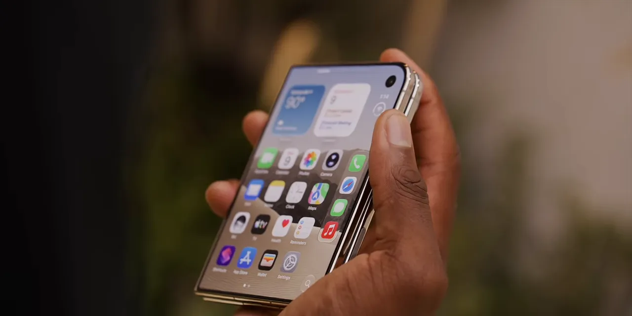 An unfolded phone held in one hand with widgets and app icons across its home screen