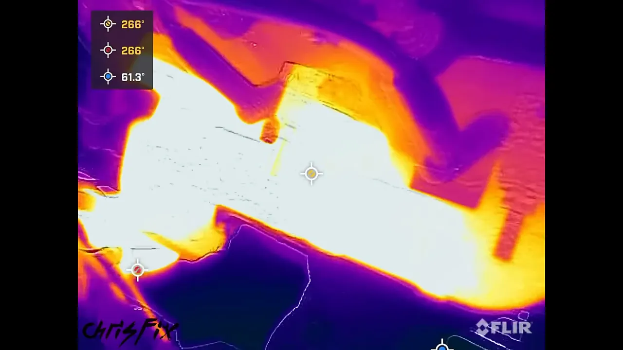 Thermal image of an exhaust manifold with a cooler orange runner beside brighter yellow and white areas