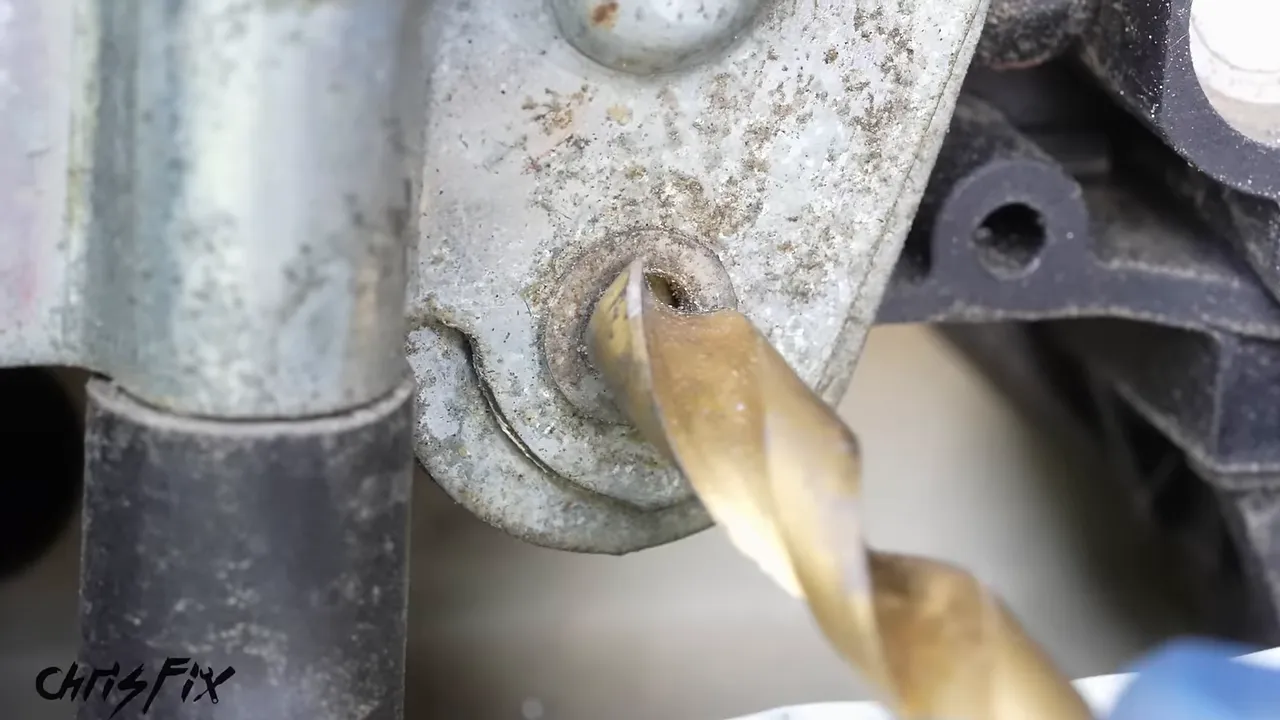 A drill bit positioned against the shoulder of a window motor mounting rivet