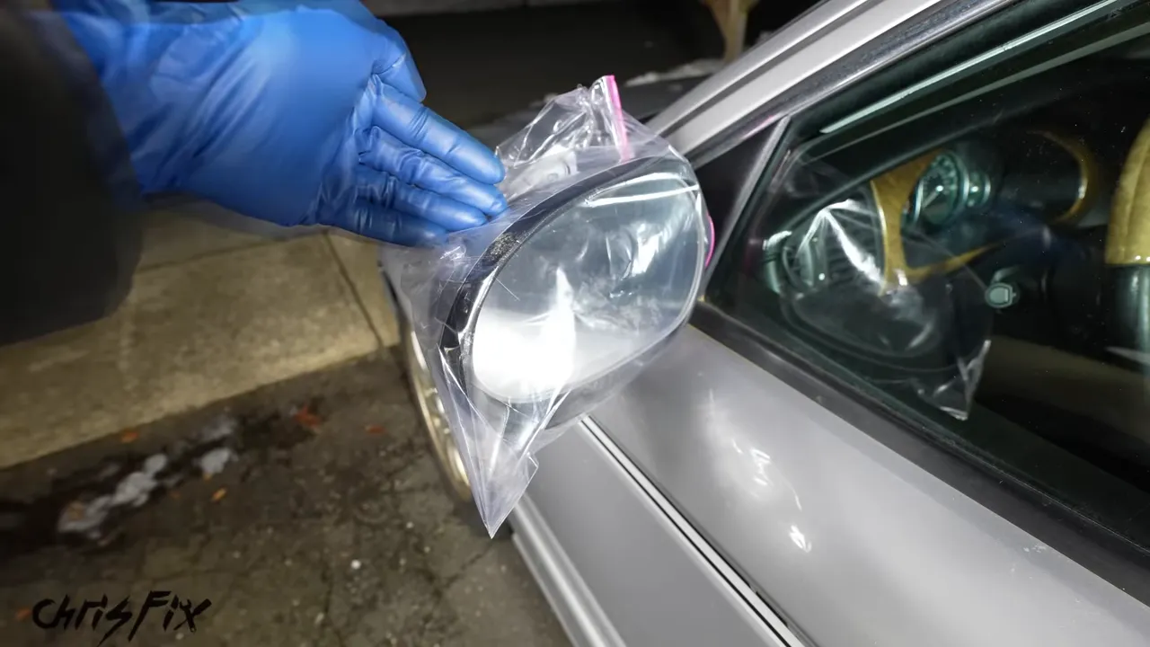 A clear resealable plastic bag fitted over a silver car side mirror