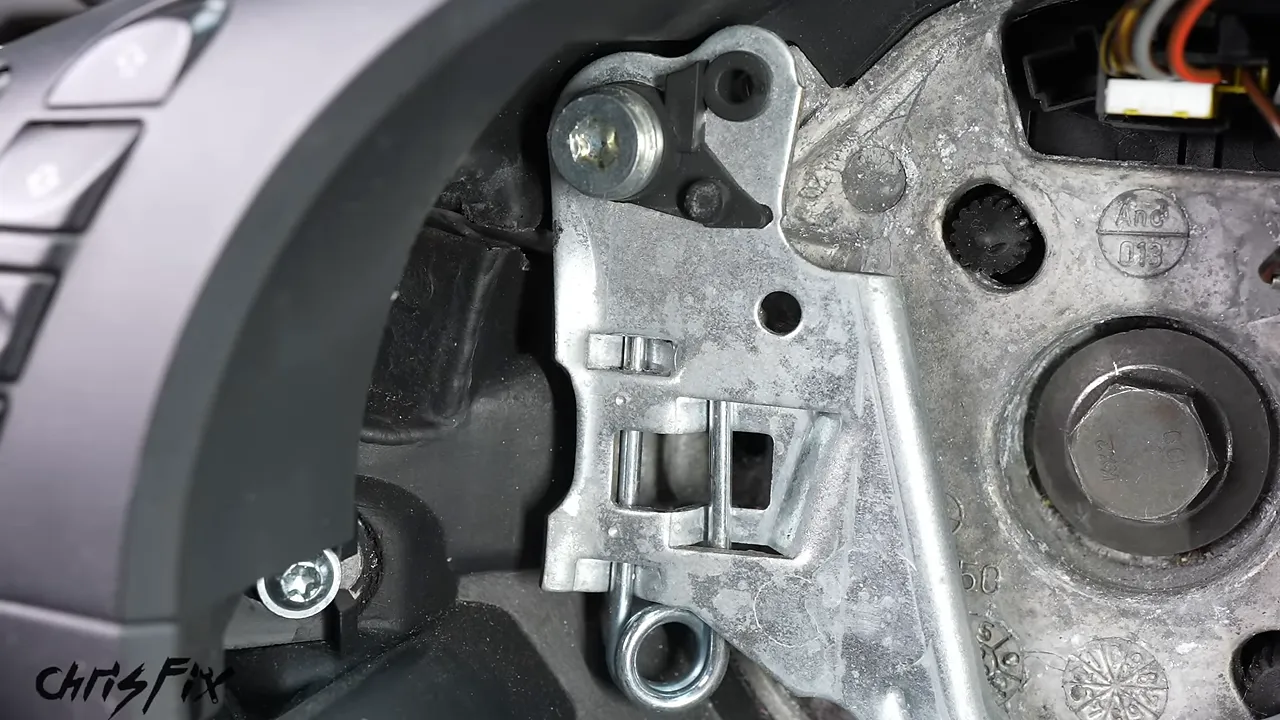 Close-up of the retaining spring inside a BMW steering wheel with the airbag removed