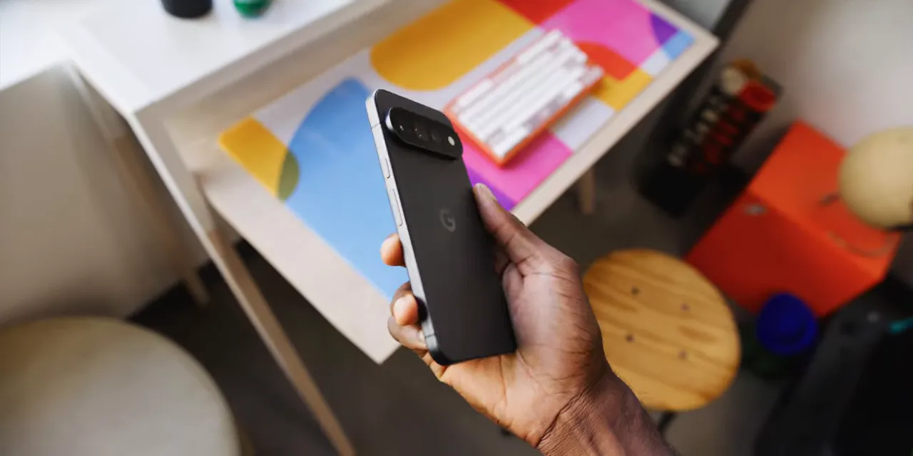Matte black Pixel held upright with its rear camera bar and dark side rails visible