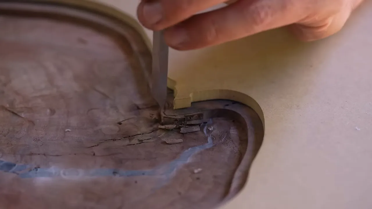 Chisel removing walnut from a tight inside curve in the routed glass recess