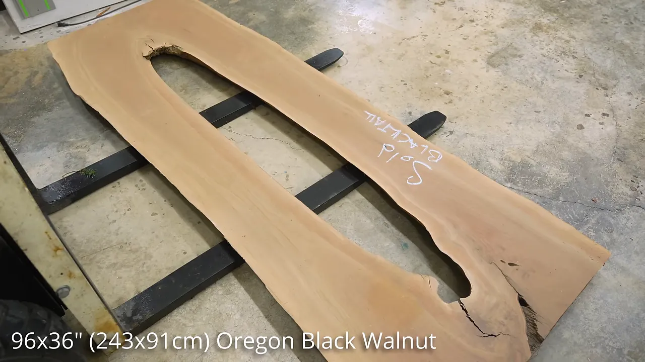 Unfinished walnut slab with a long irregular opening through its center