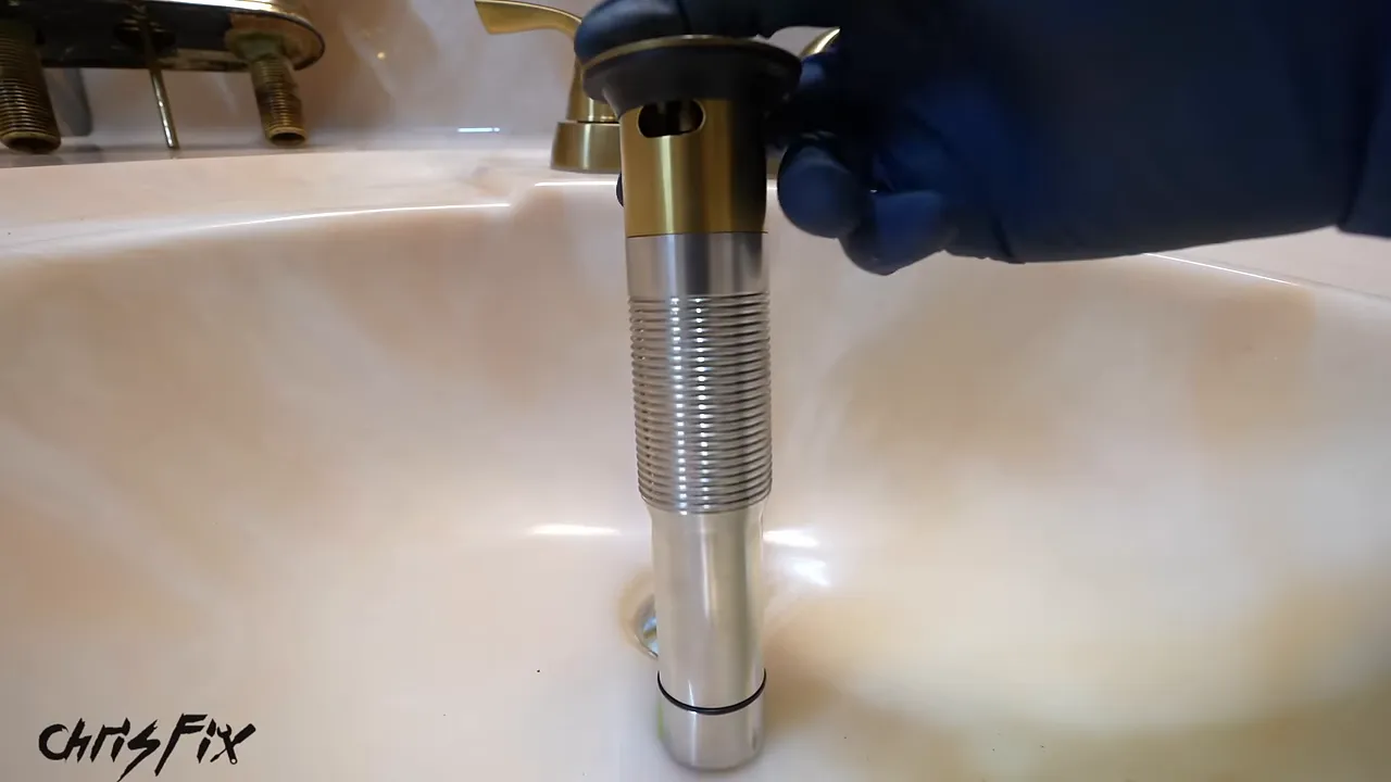 New metal drain held above the sink with its side opening facing forward and tape marking the basin