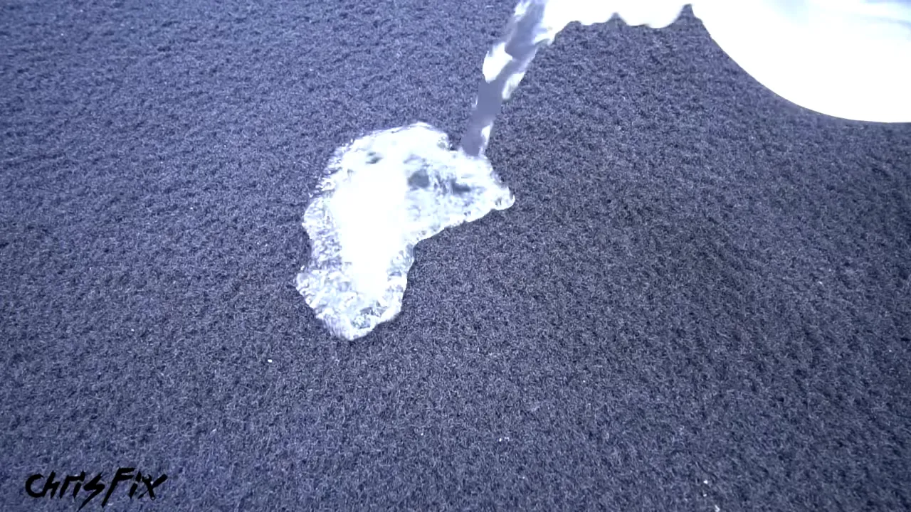 Water beading on the surface of dark carpet