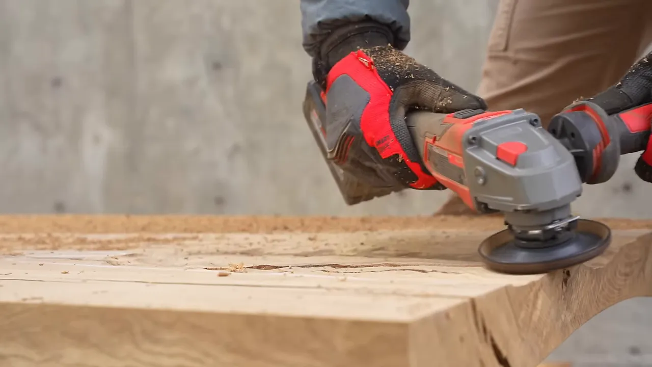 Angle grinder shaping a recessed area in the oak slab