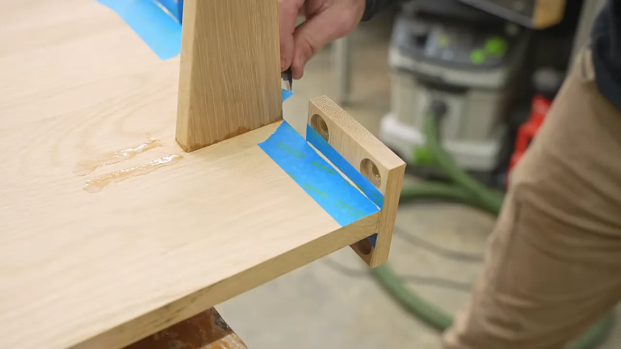 Oak leg assembly with triangular gussets and mounting tabs beneath the desktop