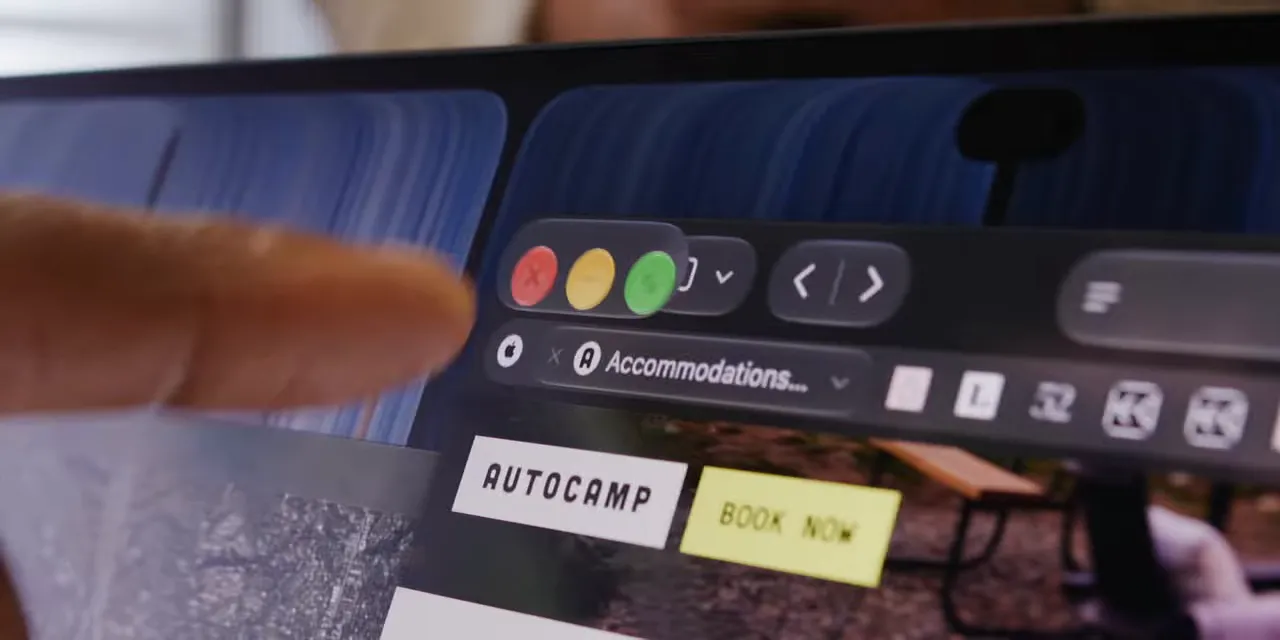 Close-up of enlarged red, yellow, and green window controls above a browser page