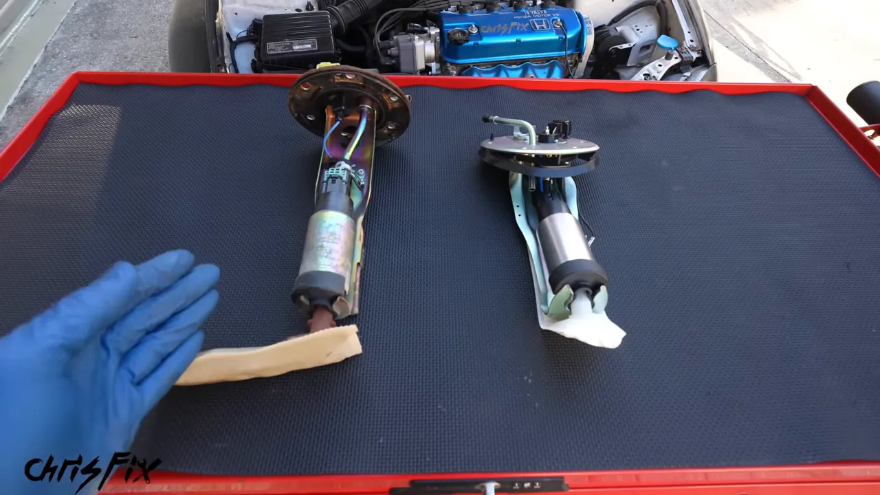 Original and replacement fuel-pump assemblies lying side by side on a work cart