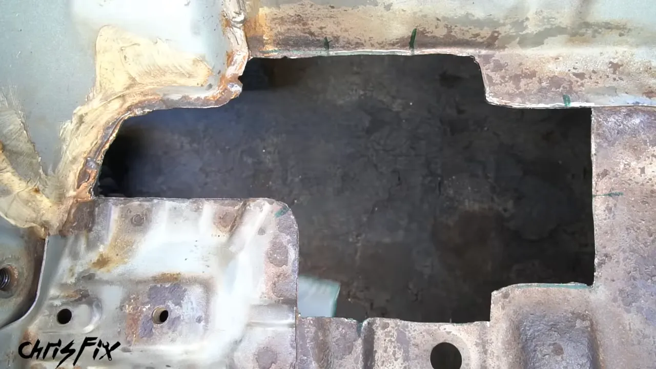 Sheet-metal patch fitted into a cut opening in the Del Sol floor