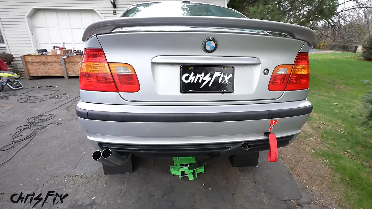 Rear of the silver BMW with twin round exhaust tips beneath the left side of the bumper