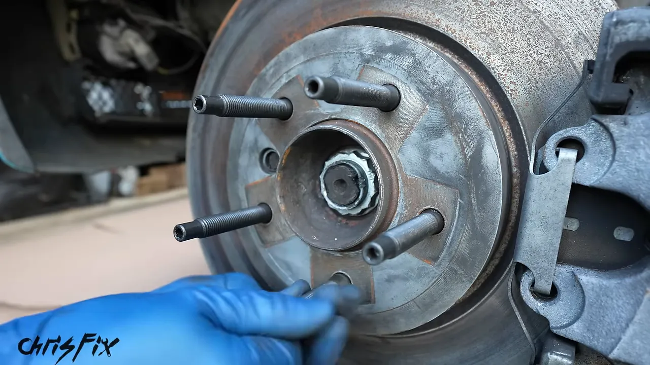 Five wheel studs installed through the brake rotor into the BMW hub