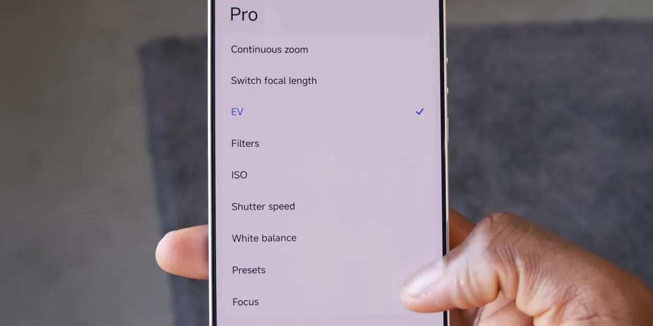 Phone screen showing Pro camera ring settings including EV, focus, ISO, shutter speed, and white balance