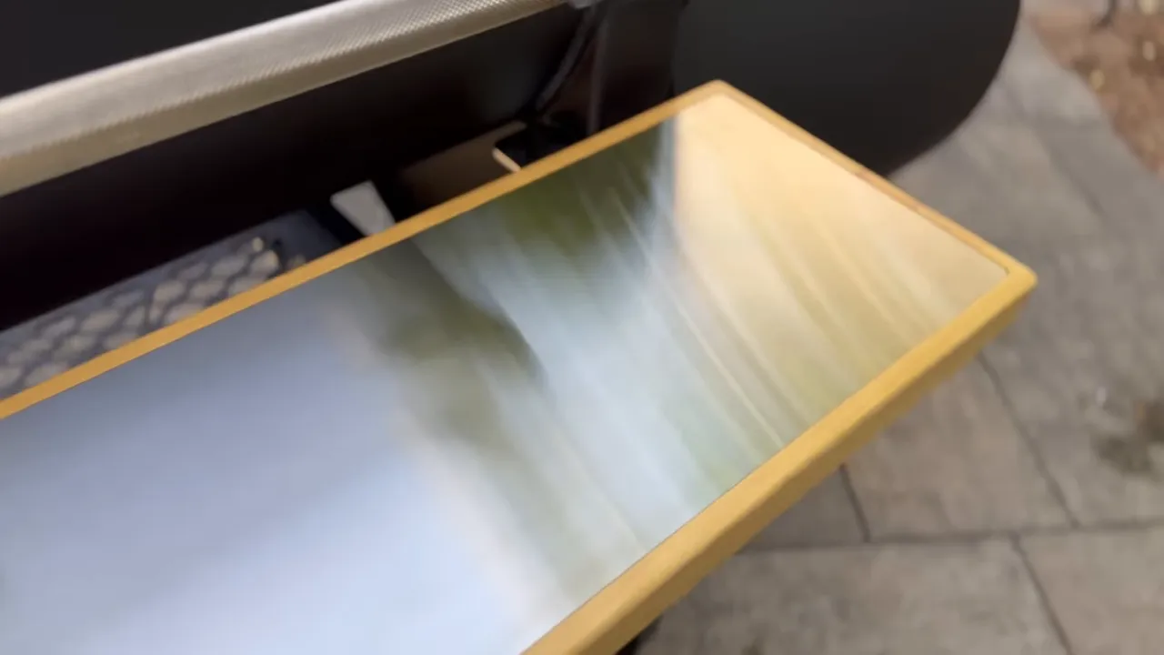 Stainless steel prep shelf inset into a wood surround beneath the smoker door