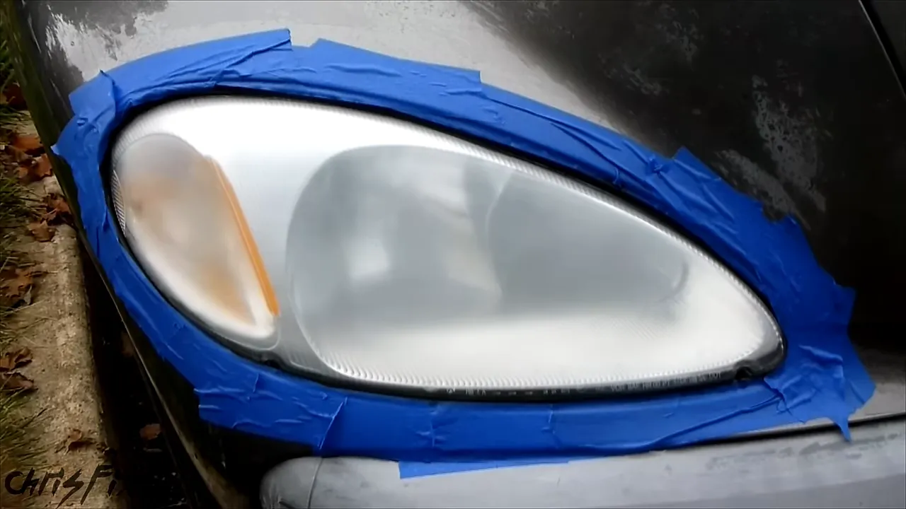 Headlight with an evenly hazy sanded surface bordered by blue painter's tape