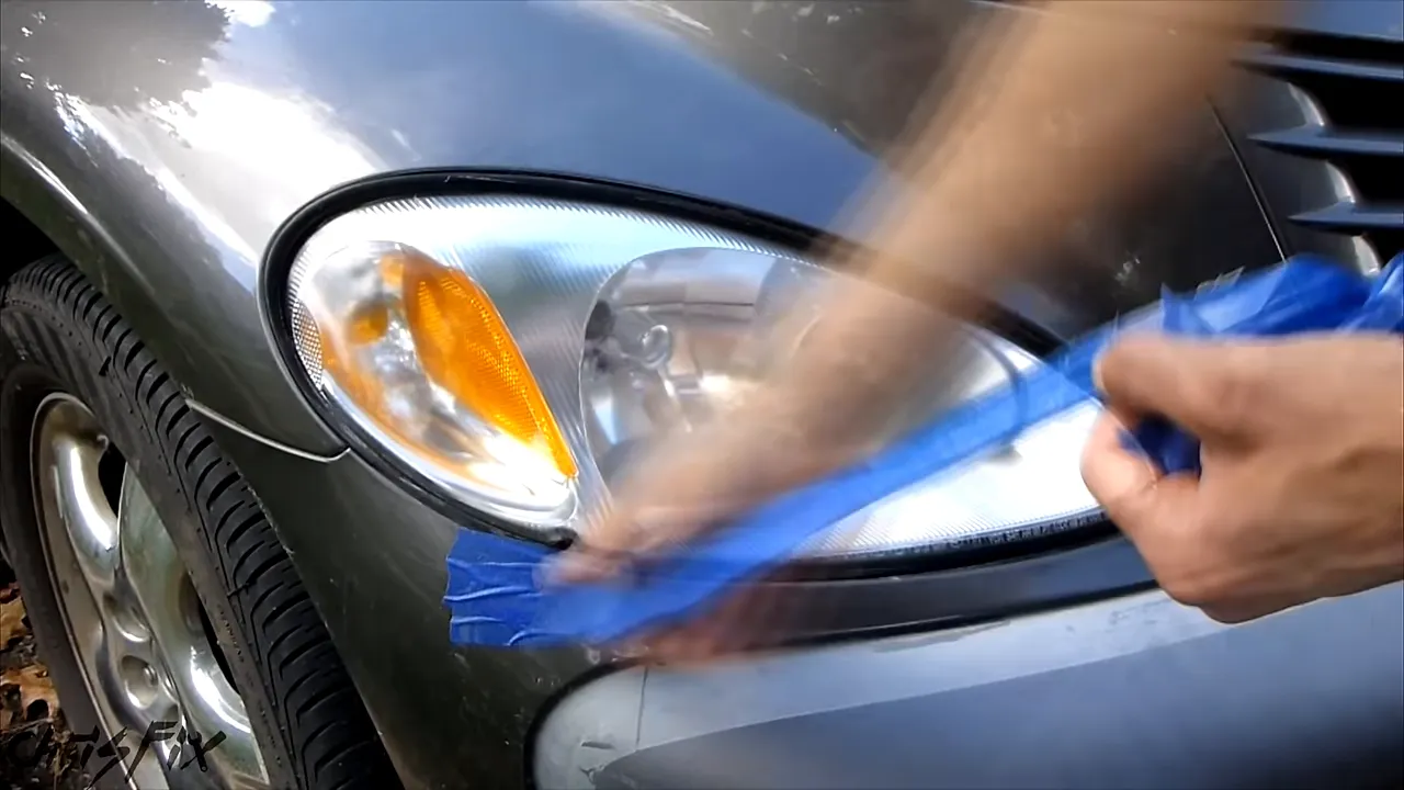 Restored clear headlight on a gray PT Cruiser with masking removed