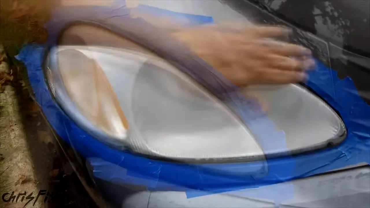 Cloudy headlight surrounded by a wide border of blue painter's tape