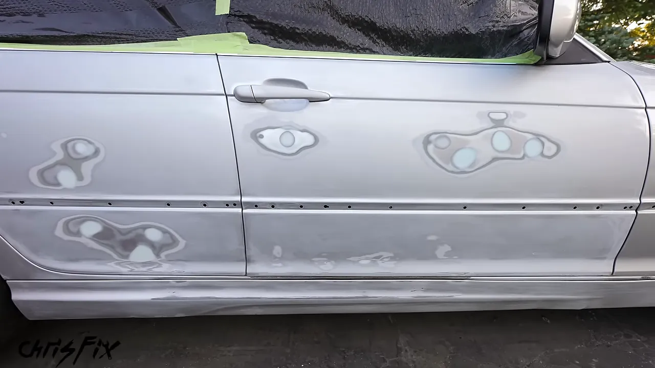 Two silver door panels sanded dull with multiple smooth filler repair patches