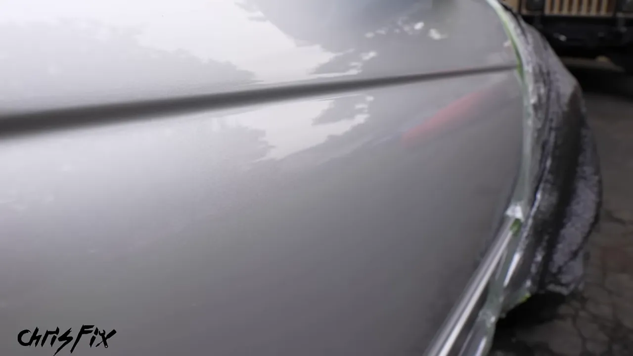 Repaired silver door showing glossy reflections after hand polishing