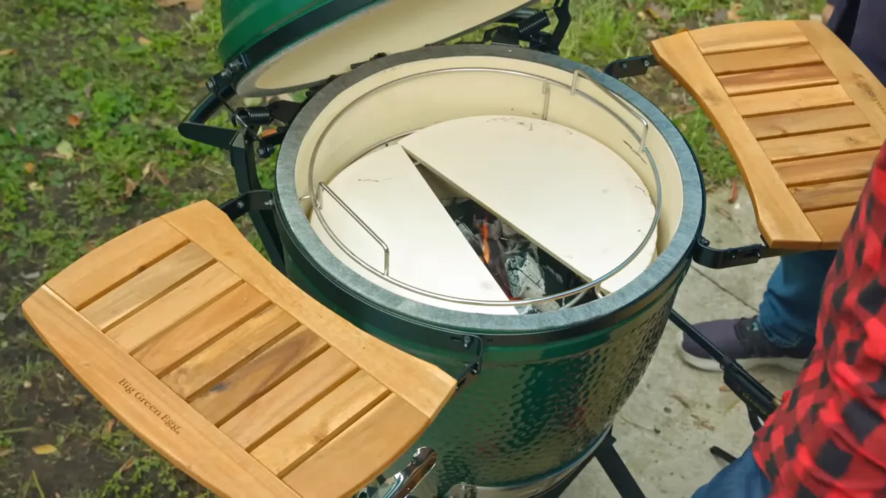 Half-moon heat deflector stones positioned with a wedge-shaped gap over the charcoal