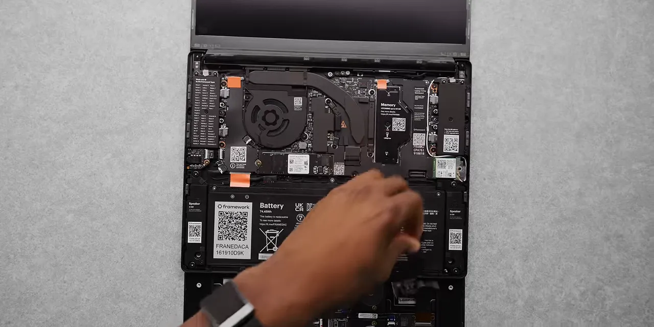 Framework laptop internals showing the cooling fan, labeled memory module, and other circuit boards