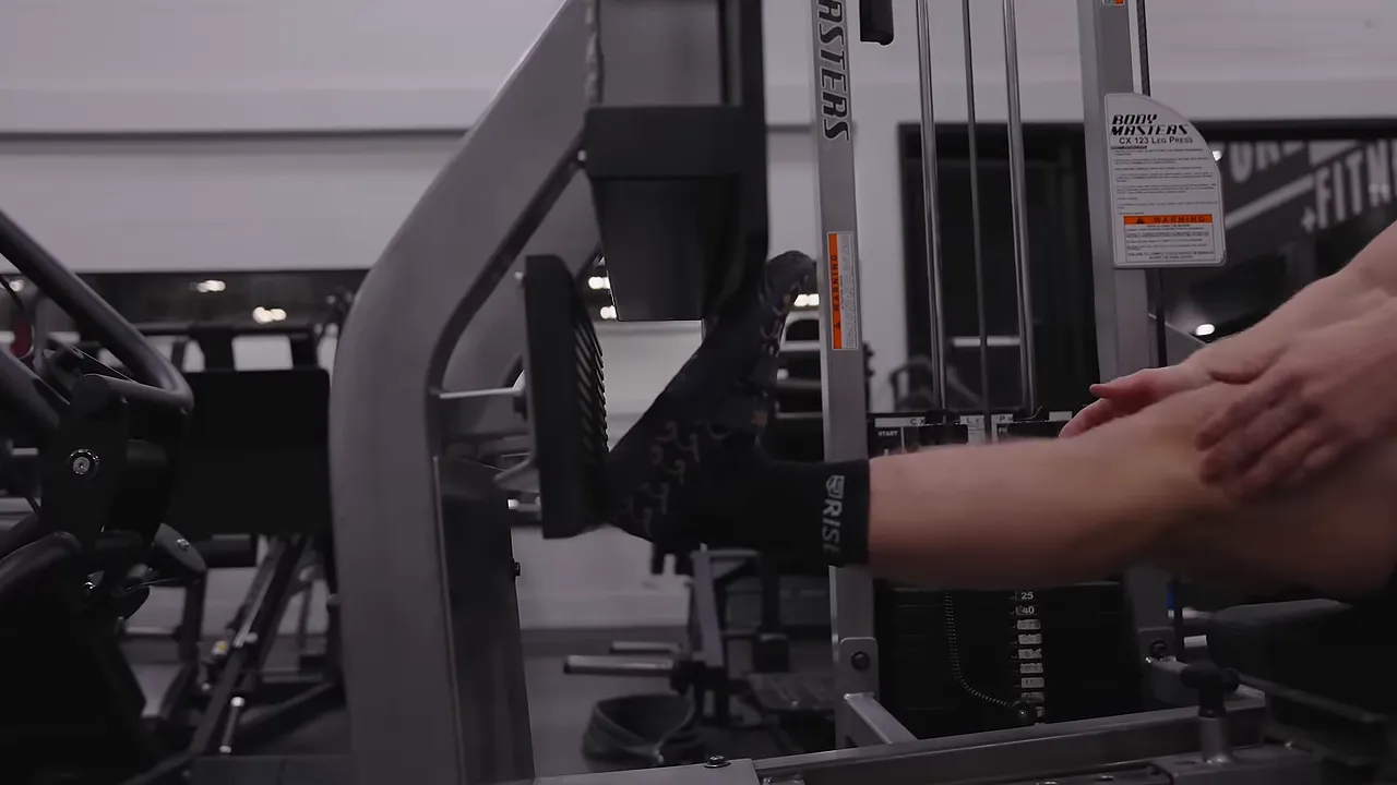 Close-up of Jeff's feet on the lower portion of a leg press footplate