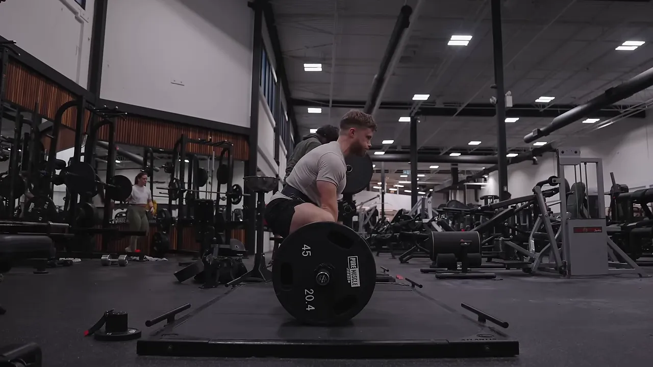 Side view of Jeff gripping a deadlift bar with bent knees and low hips