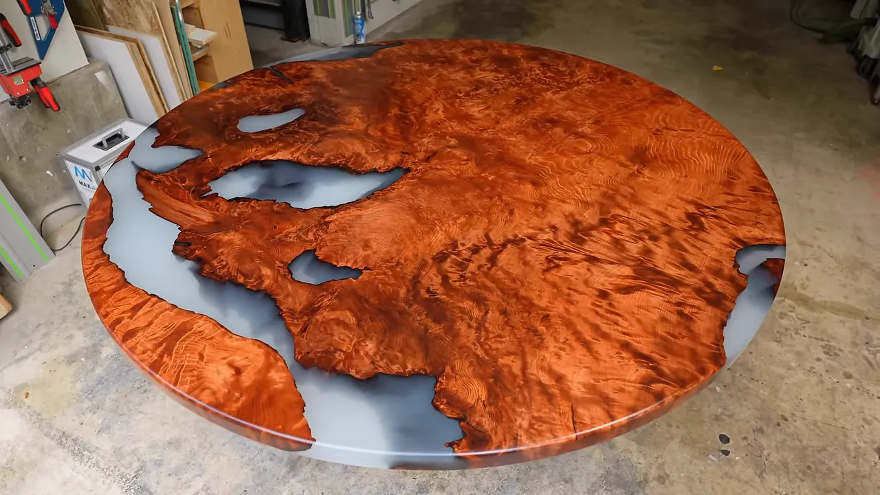 Finished circular redwood piece with richly figured orange wood and pale translucent epoxy