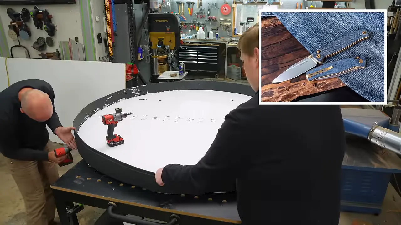 Two people fitting black flexible edging around a white circular mold base