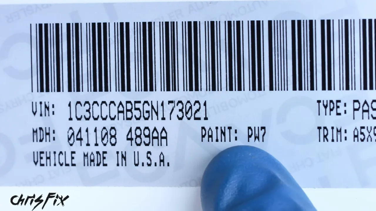 Door jamb label with the paint code PW7 beside a blue-gloved finger